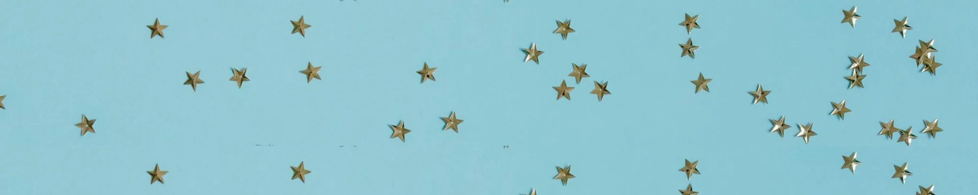 Gold confetti stars on a bright blue background