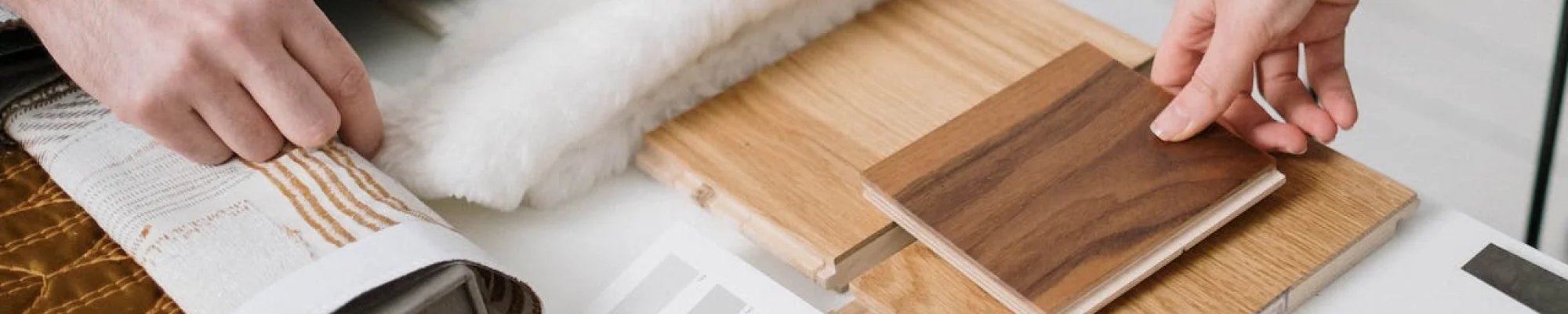Comparing flooring samples in a design consultation
